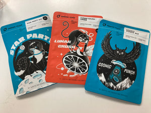 Packs of Omega Yeast Star Party, Lunar Crush, and Cosmic Punch fanned out on a white table.