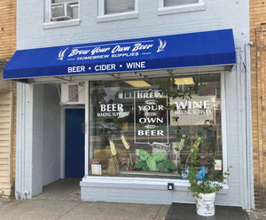 Brew Your Own Beer storefront on Darby Rd in Havertown, PA. The facade is painted light blue with a dark blue awning. 